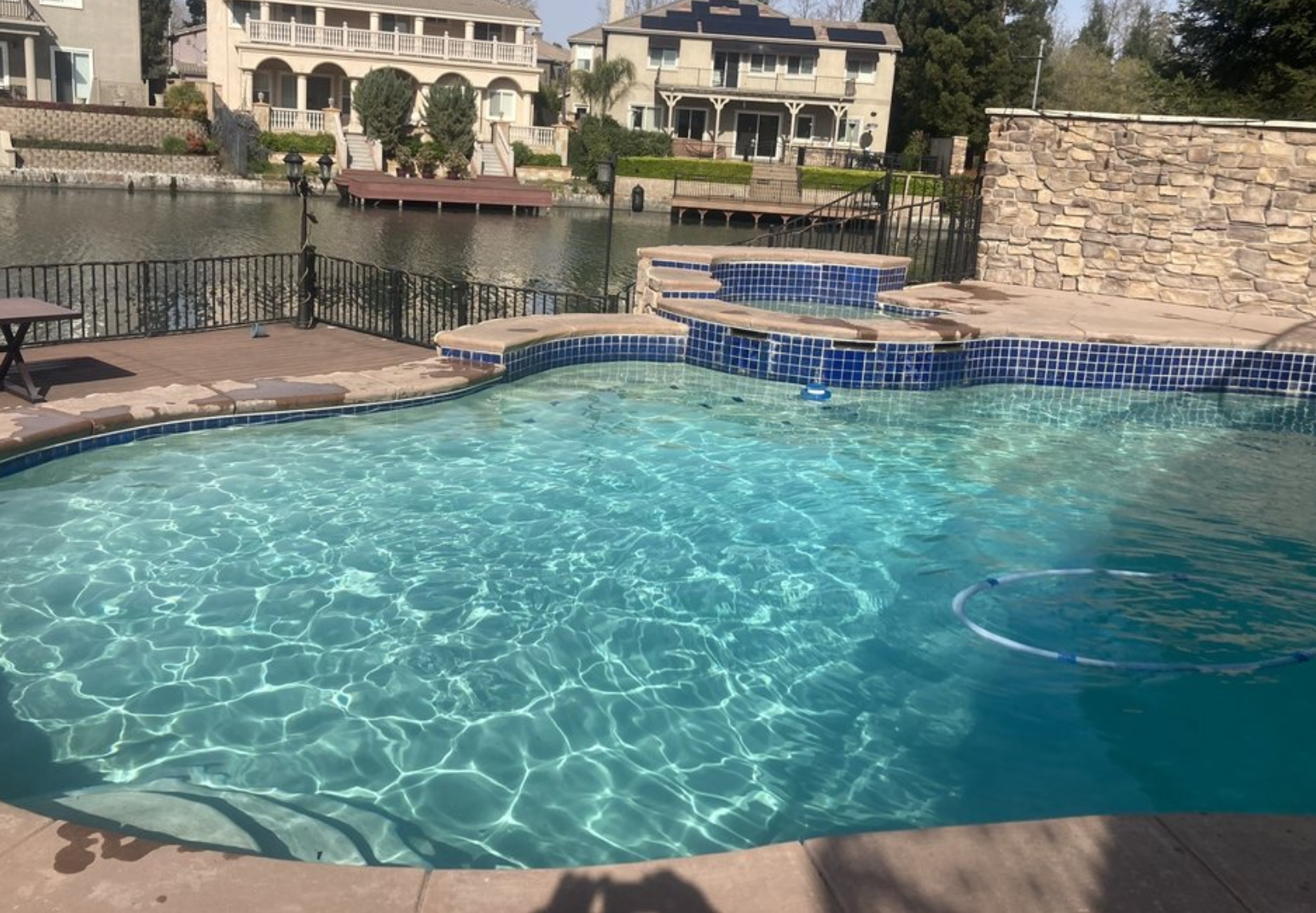 Sparkling blue backyard pool serviced by EZ Pools in Stockton
